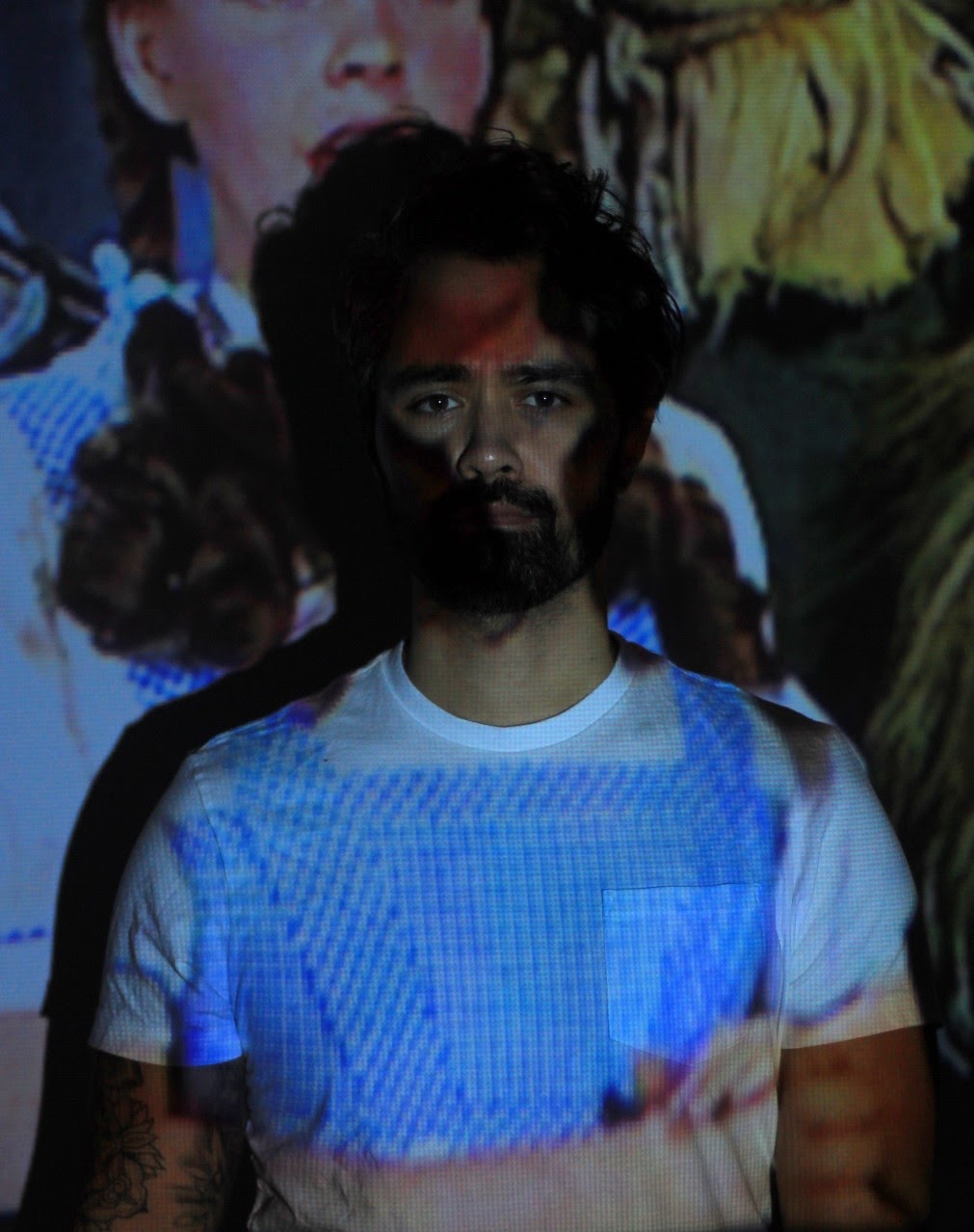 Image of Cameron Cain Chong with projection of Wizard of Oz across his face